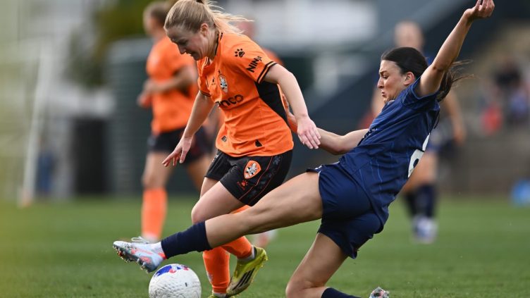 Murphy Agnew of Brisbane is tackled by Talia Kapetanellis of Central Coast at Gioca Stadium.