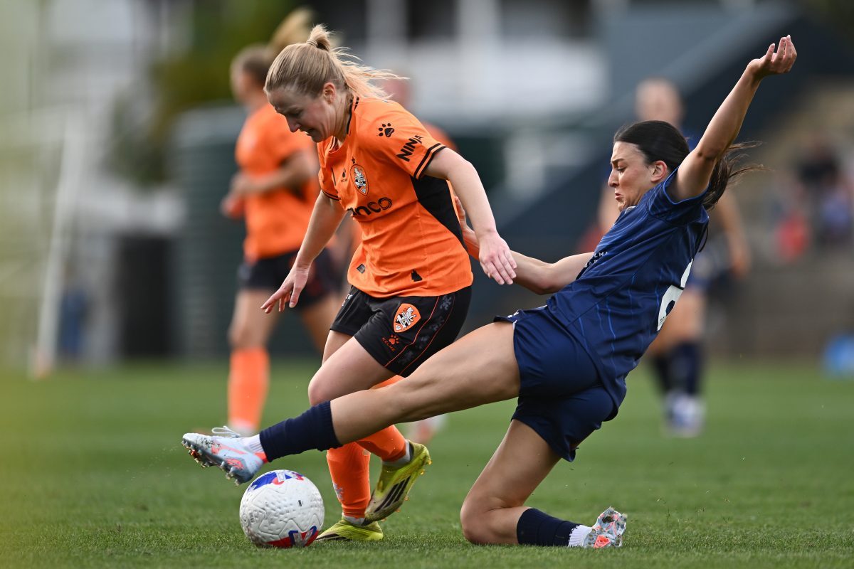 Murphy Agnew of Brisbane is tackled by Talia Kapetanellis of Central Coast at Gioca Stadium.