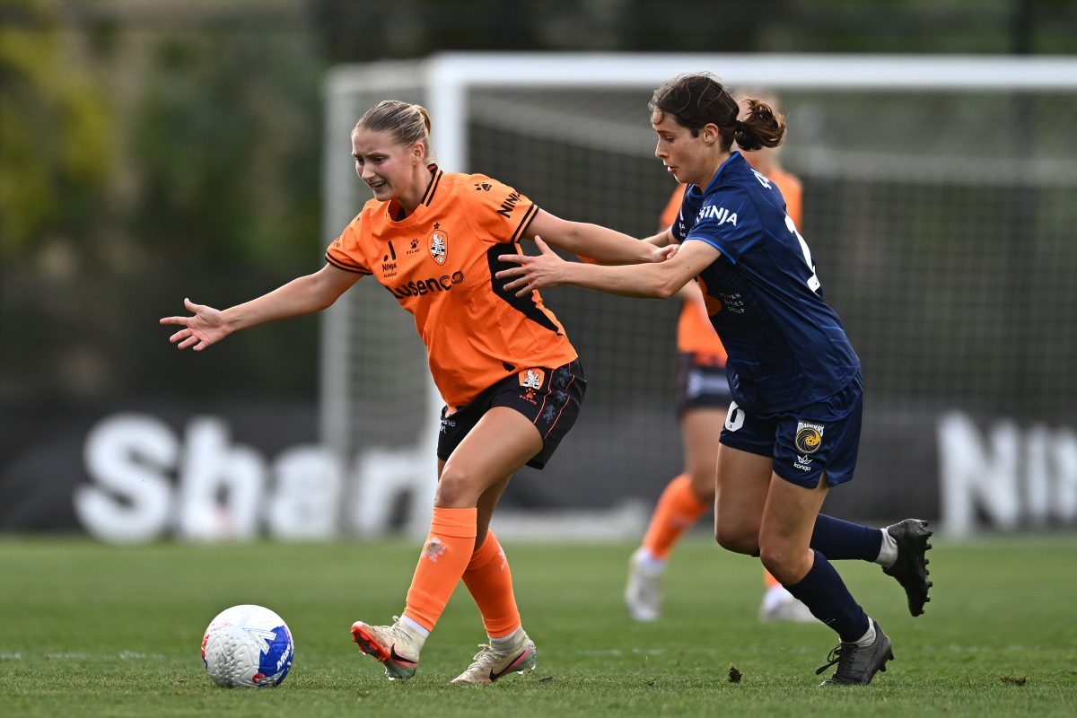 Zara Kruger of Brisbane controls the ball under pressure from Tess Quilligan of Central Coast at Gioca Stadium.