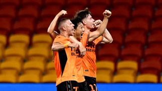 Tae-Hee Nam of the Roar celebrates with team mates after scoring a goal at Suncorp Stadium.