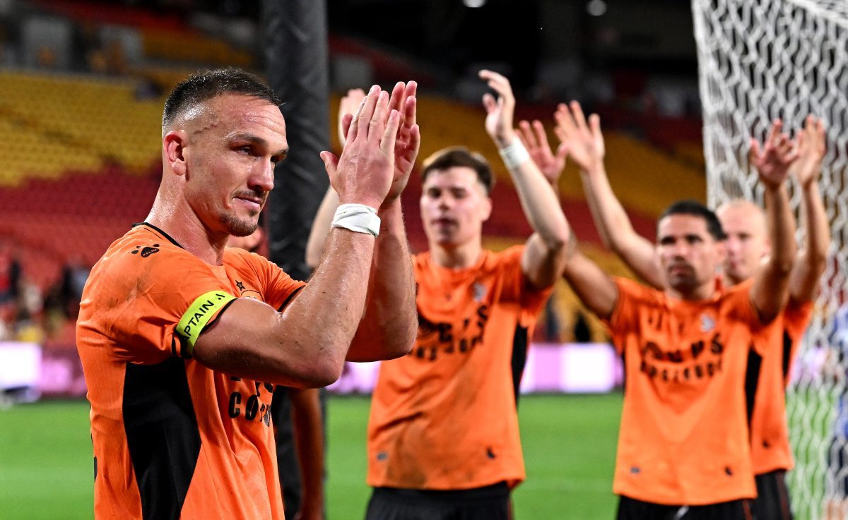Tom Aldred of the Roar celebrates victory after the match at Suncorp Stadium.