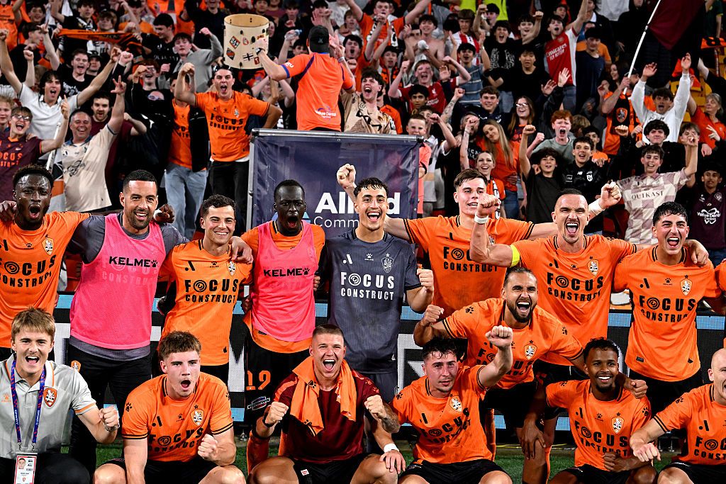 The Roar players celebrate victory after the match at Suncorp Stadium.