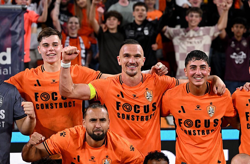 Tom Aldred of the Roar and team mates celebrate victory after the match at Suncorp Stadium.