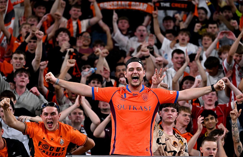 The Brisbane Roar fans celebrate victory after the match at Suncorp Stadium.