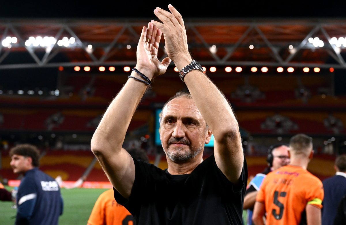 Head Coach Michael Valkanis of the Roar thanks the fans after the match at Suncorp Stadium.